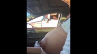 Woman shows her tits while driving and squeezes her puffies